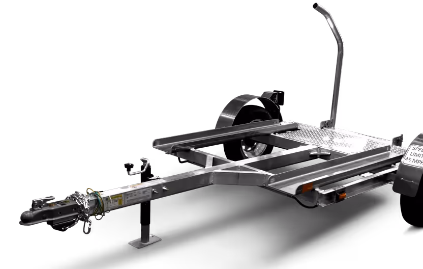 Metal trailer frame with a hitch, spare wheel, and a handbrake lever on a white background.