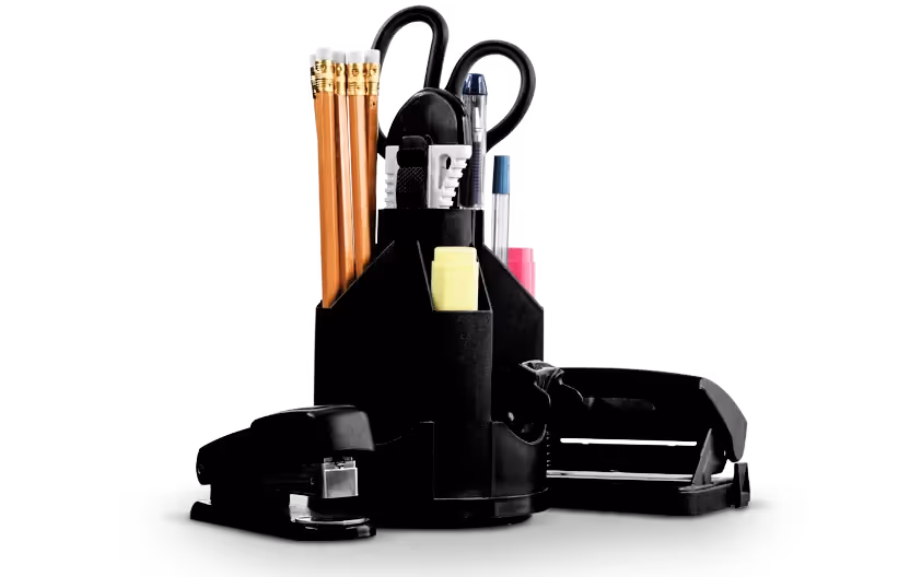 Black desk organizer holding pencils, pens, scissors, highlighter, stapler, and tape dispenser.