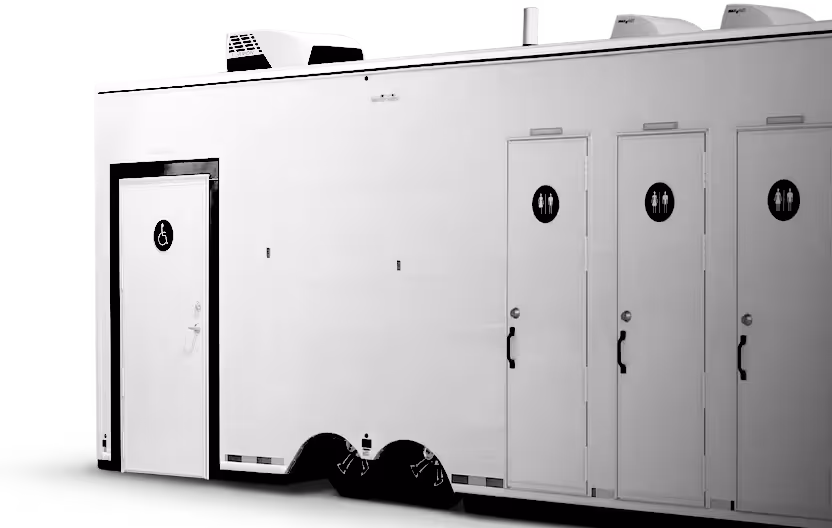 White portable restroom trailer with one accessible door and three unisex restroom doors.