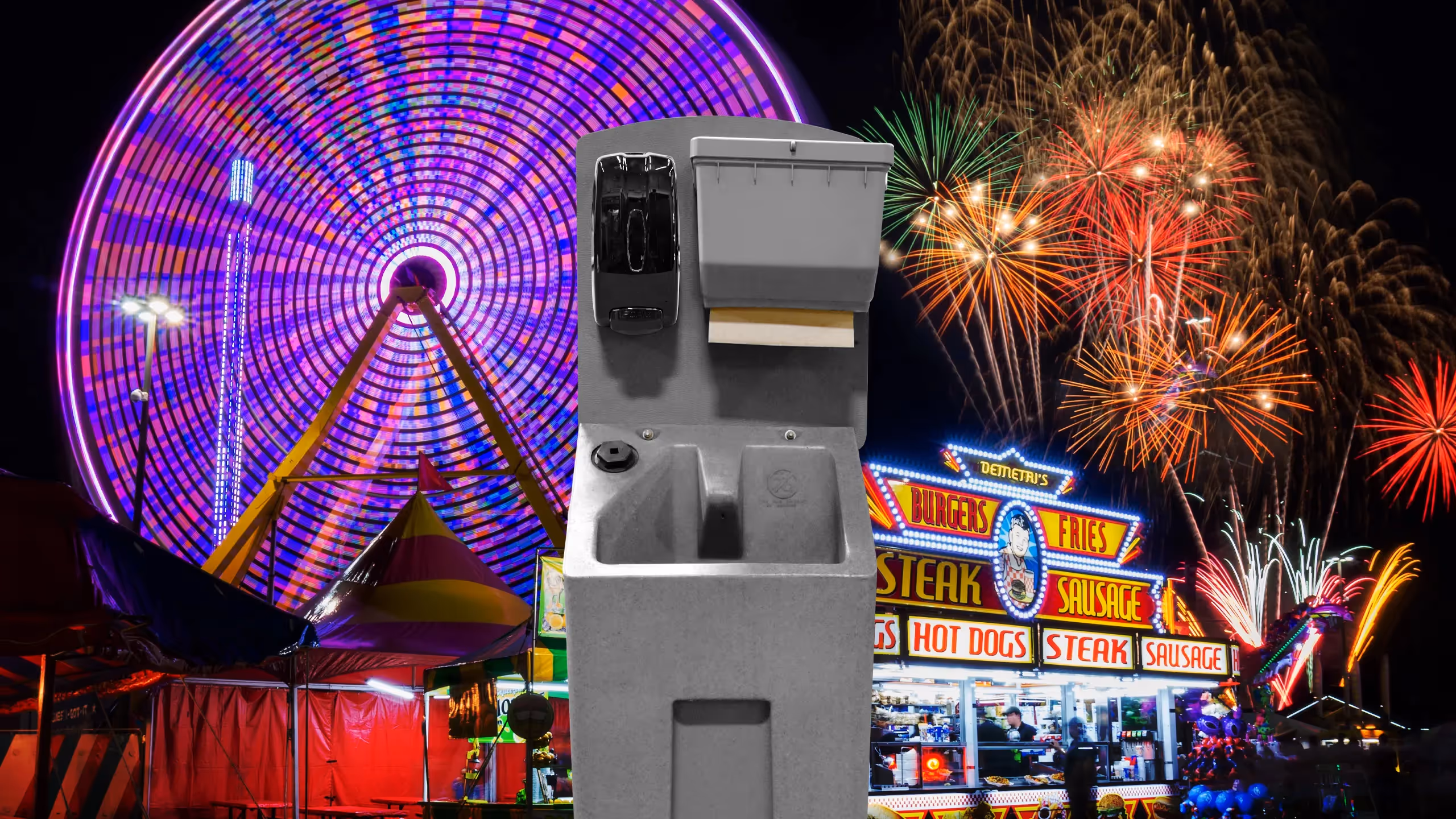 Handwashing station in front of a carnival with a Ferris wheel and fireworks in the background.