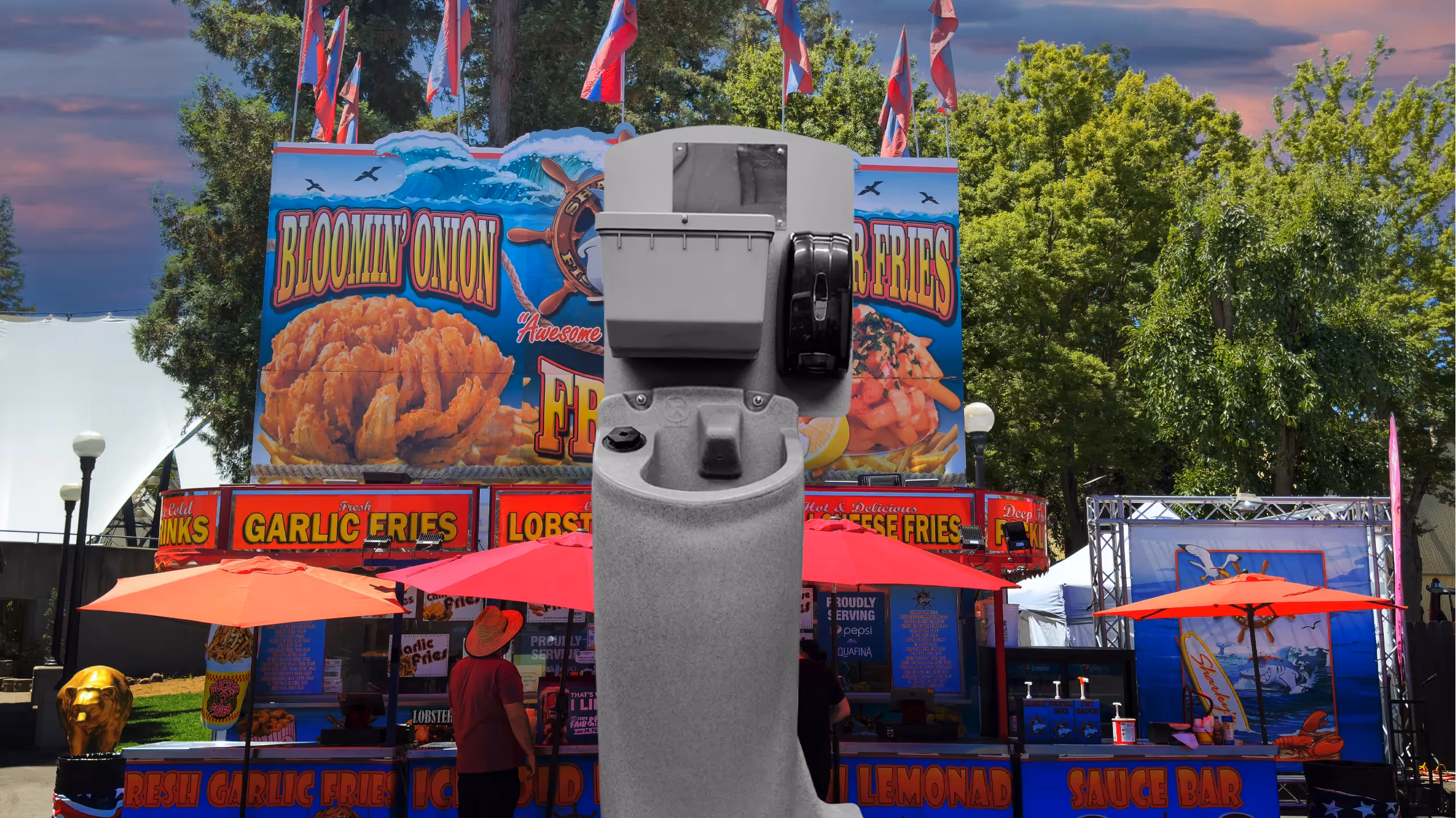 A Pro-12 device in front of a food stand featuring fried food and red umbrellas.