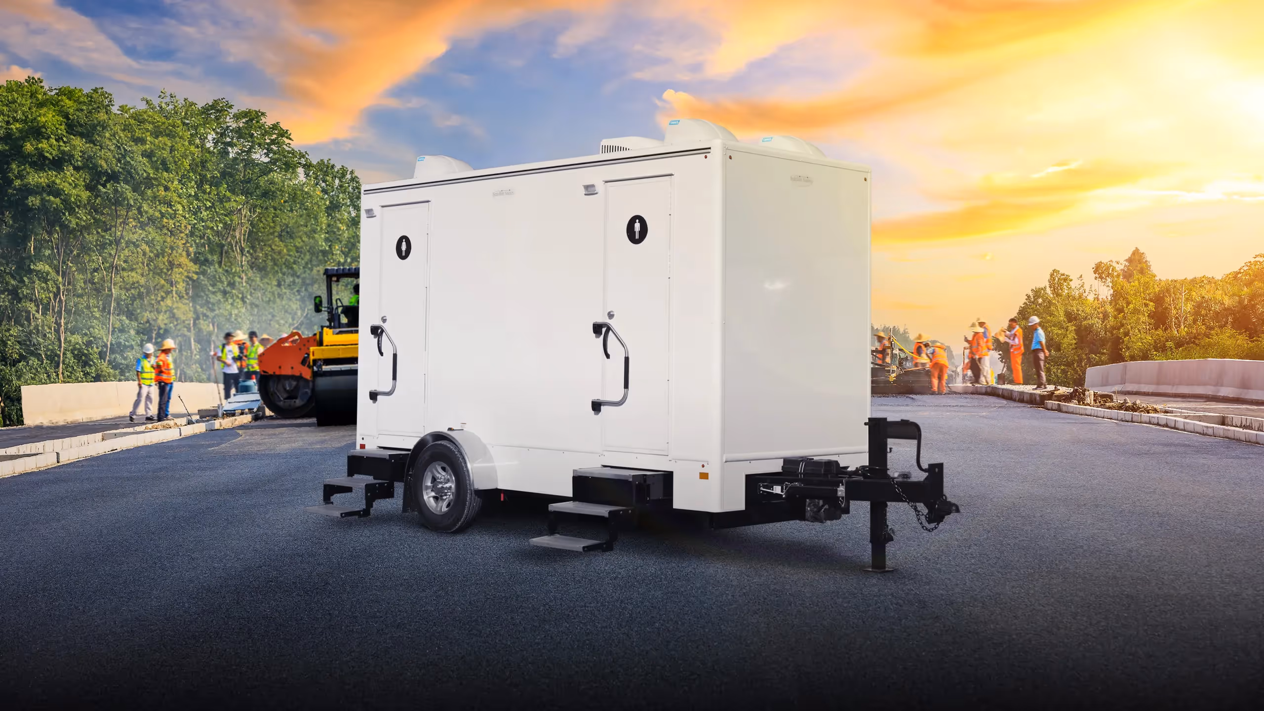 A 6x14' mobile restroom trailer with two doors and four stations on a construction site.
