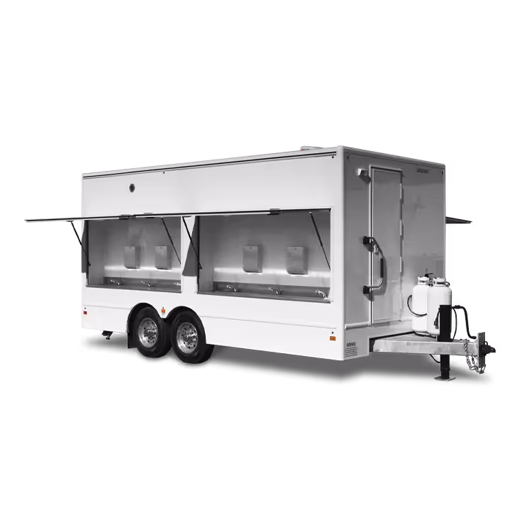 A 12-station sink trailer with multiple compartments and serving windows, on a towable chassis.