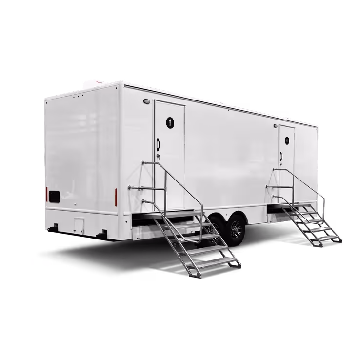 White trailer with two staircases and multiple restroom stations, set against a black background.