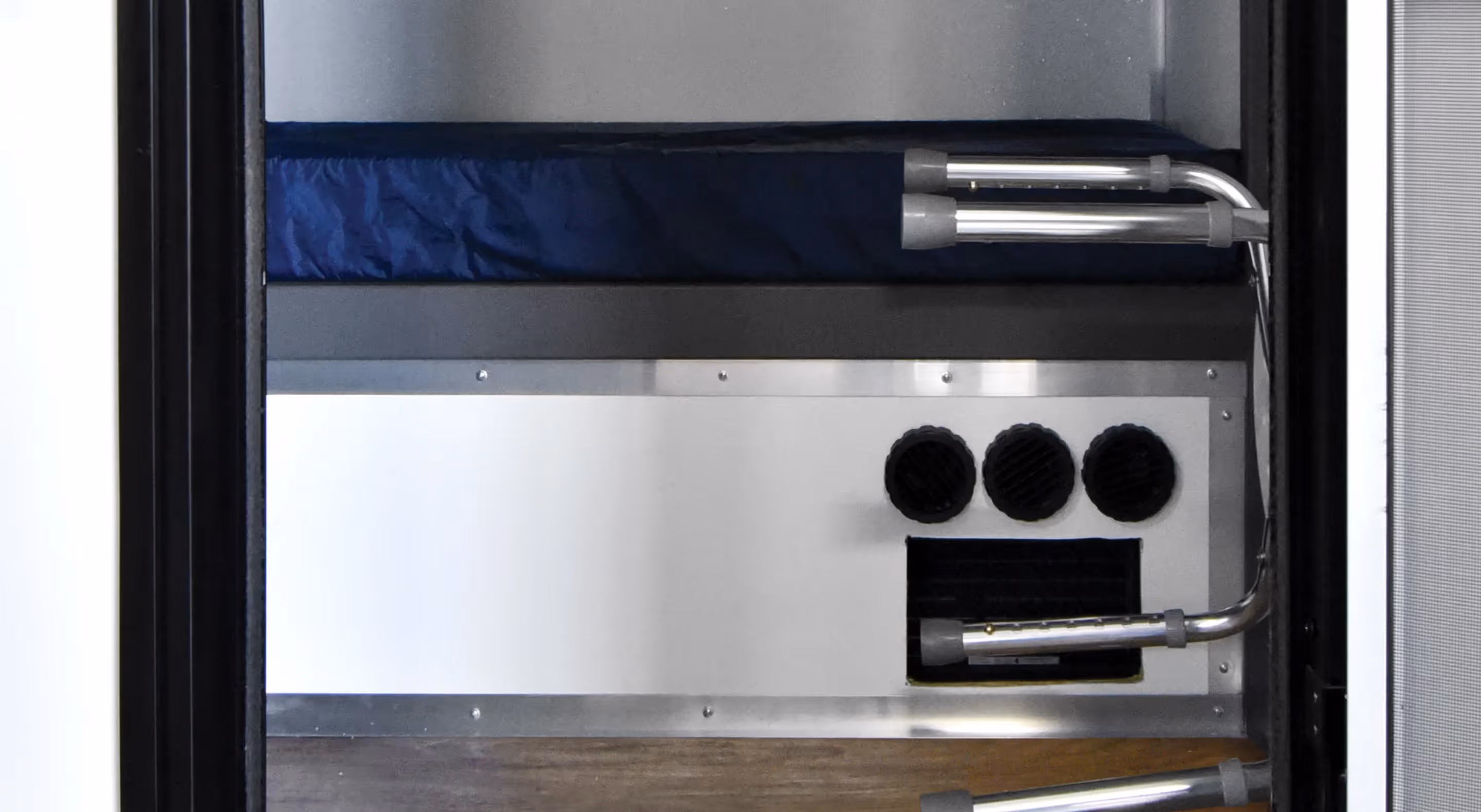 Interior view of a 10-man privacy bunk with a blue mattress and ventilation features.