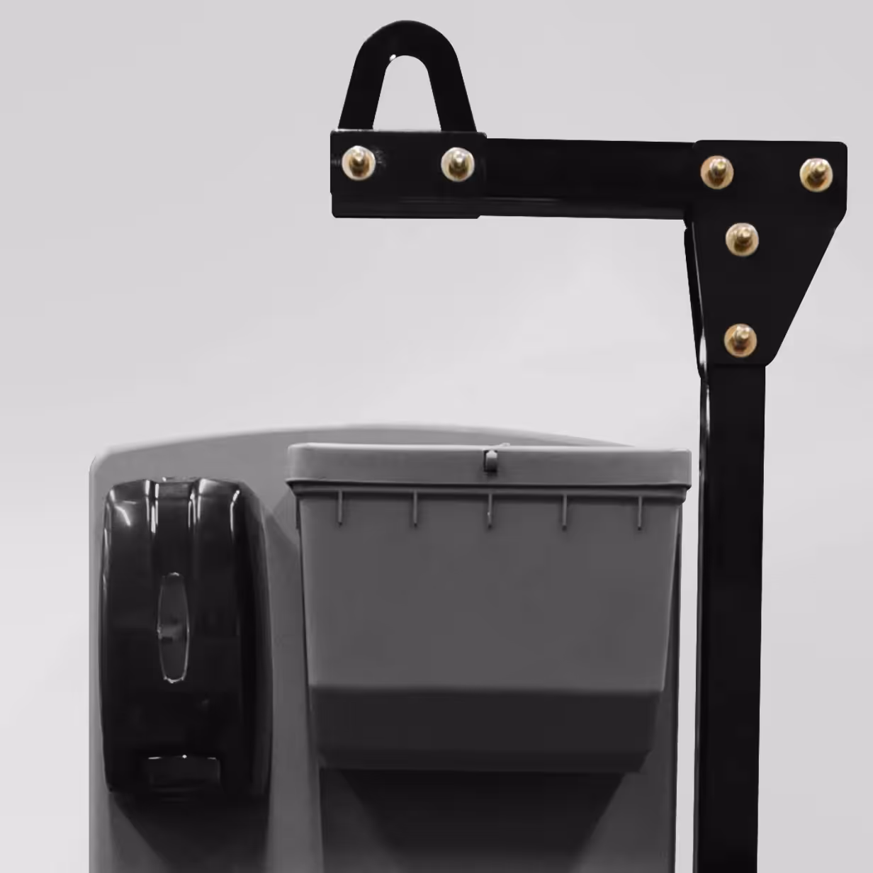 Gray plastic container with a black dispenser mounted on a black metal arm with bolts.