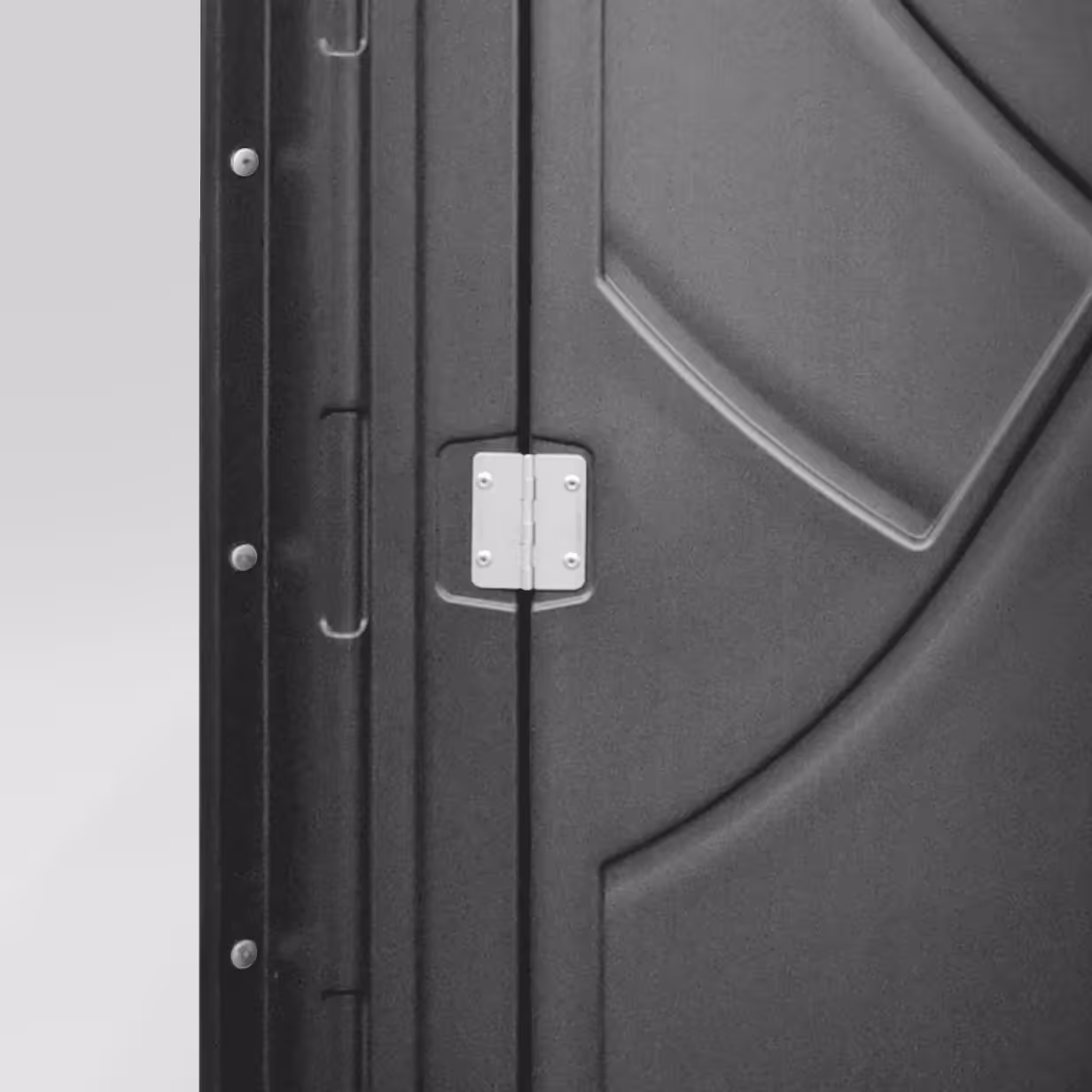 Close-up of a silver metal hinge attached to a dark gray door with panel designs.