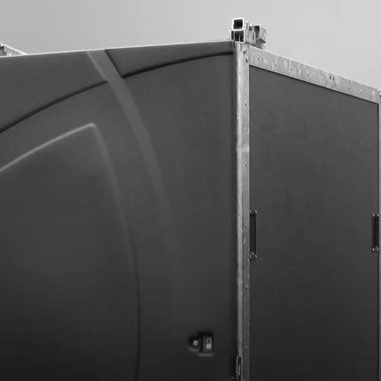 Close-up of a large black portable room or enclosure with metal framing and a latch.
