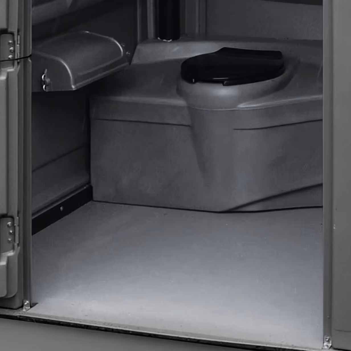 Interior of a portable toilet showing a gray plastic holding tank with a black lid.