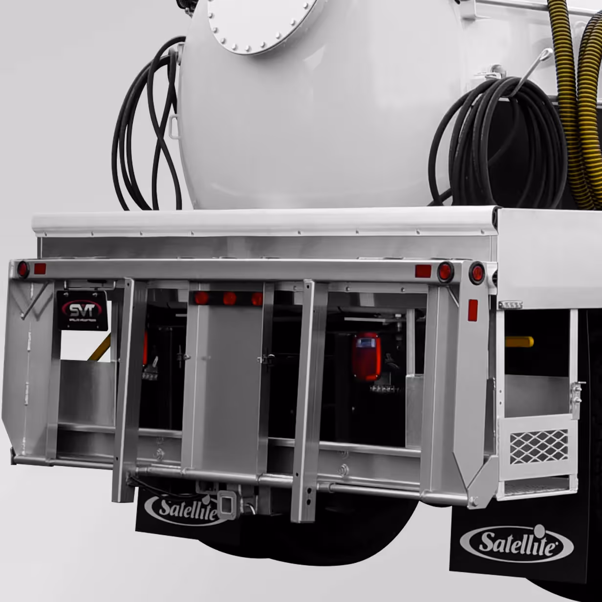 Rear view of a silver truck flatbed with coiled hoses and Satellite mud flaps attached.