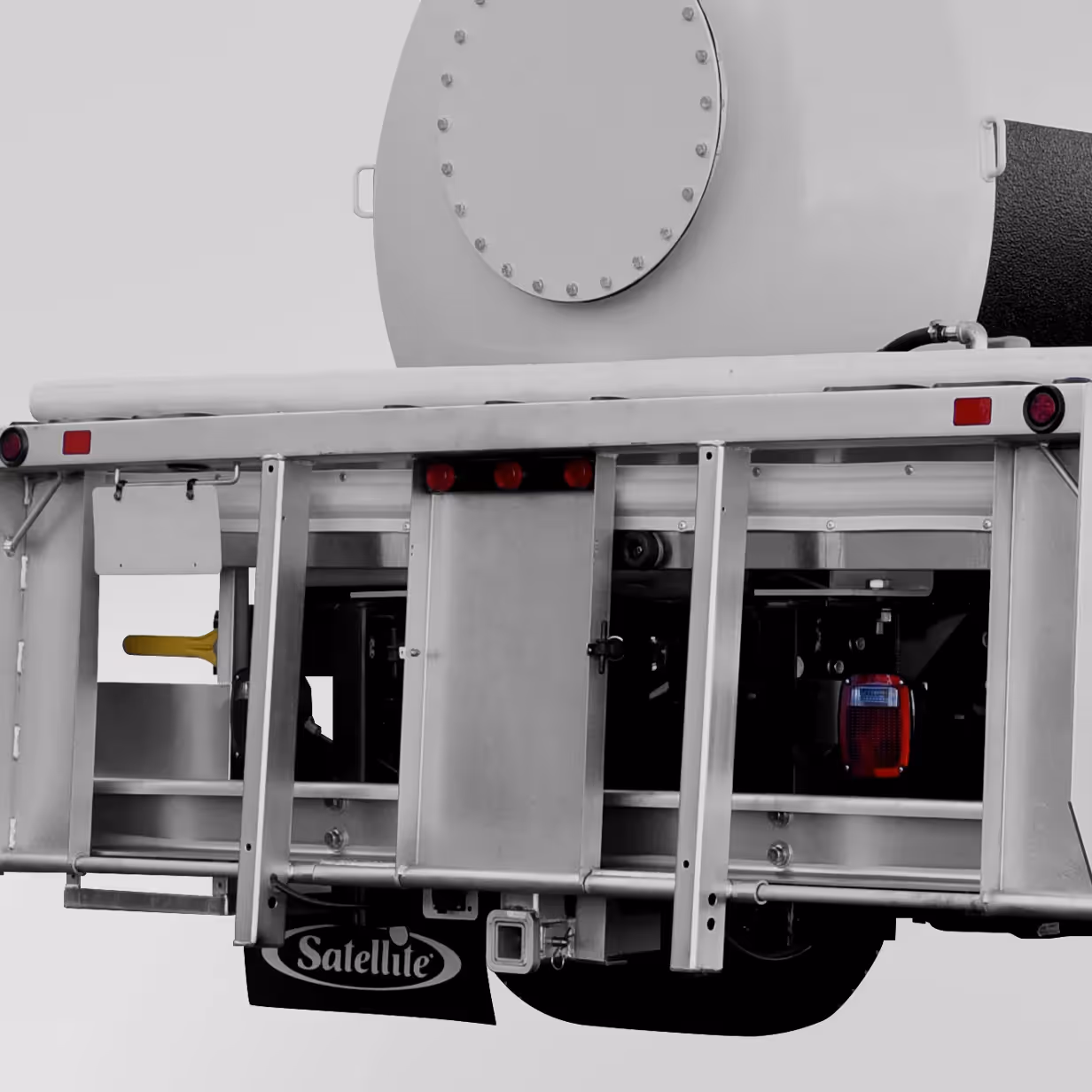 Rear section of a utility trailer with metal frame, red lights, and Satellite logo mudflap.