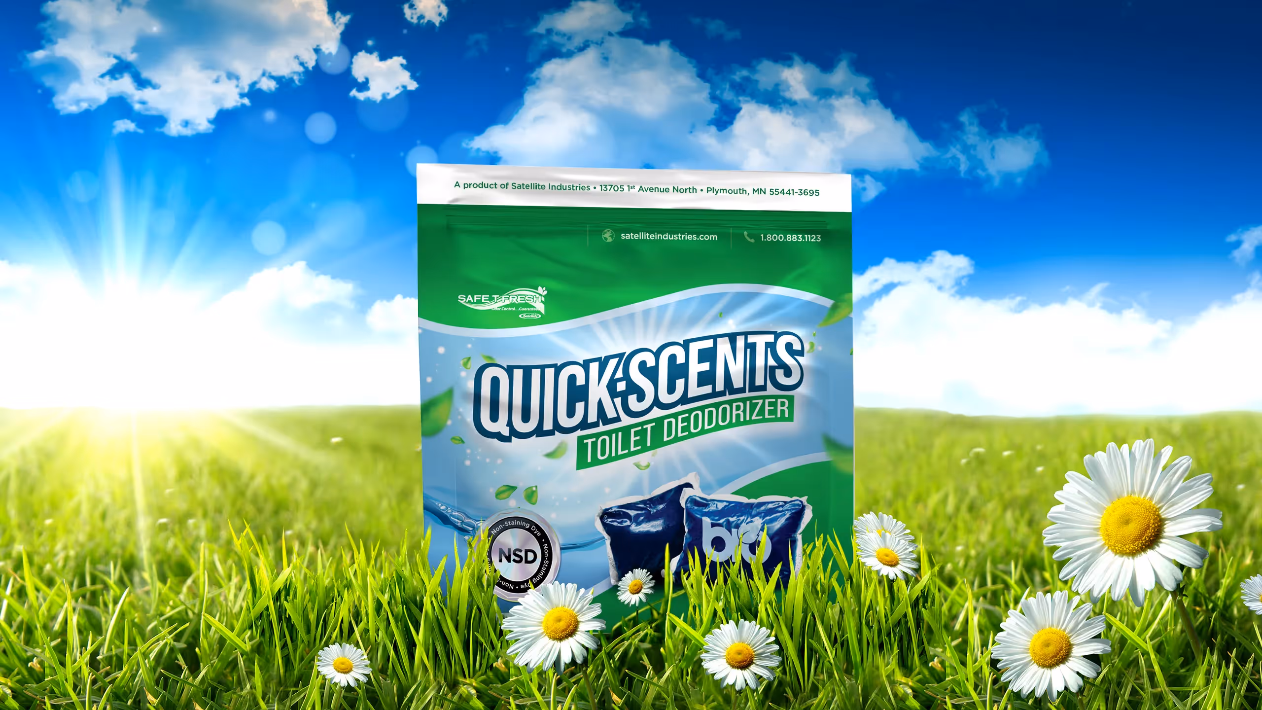 QuickScents Toilet Deodorizer packet in a grassy field under a blue sky with daisies.