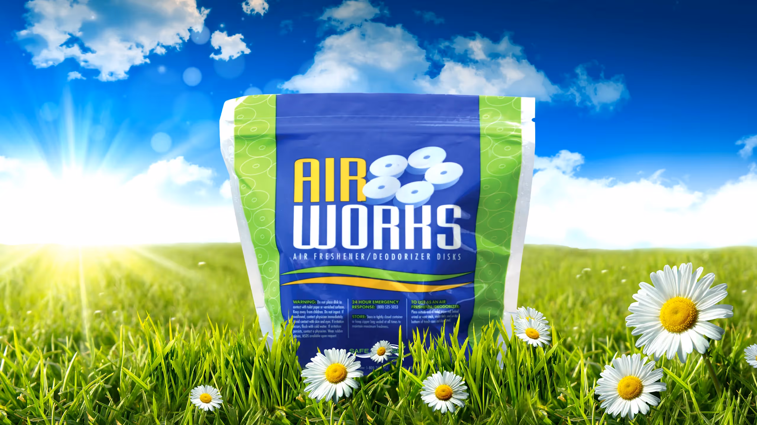 Air Works air freshener package displayed against a bright sky and grassy field with daisies.
