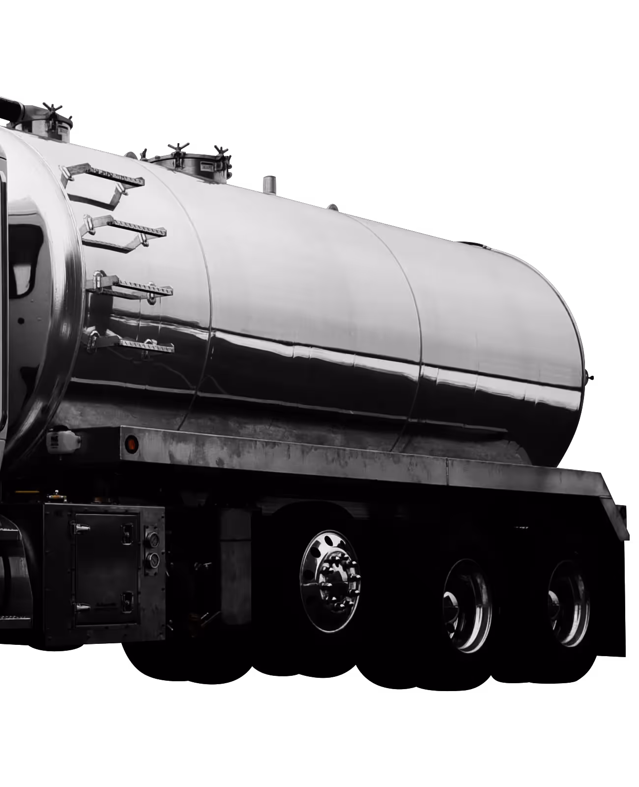 Shiny silver tanker truck on a black background, showcasing its cylindrical shape and wheels.
