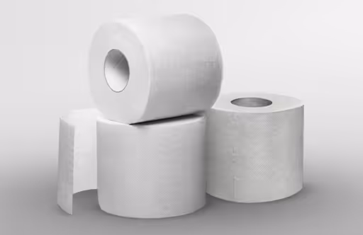 Four rolls of white toilet paper stacked together on a plain background.