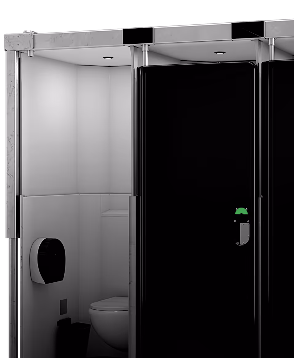 Modern toilet module featuring sleek black design, enclosed space, and wall-mounted paper dispenser.