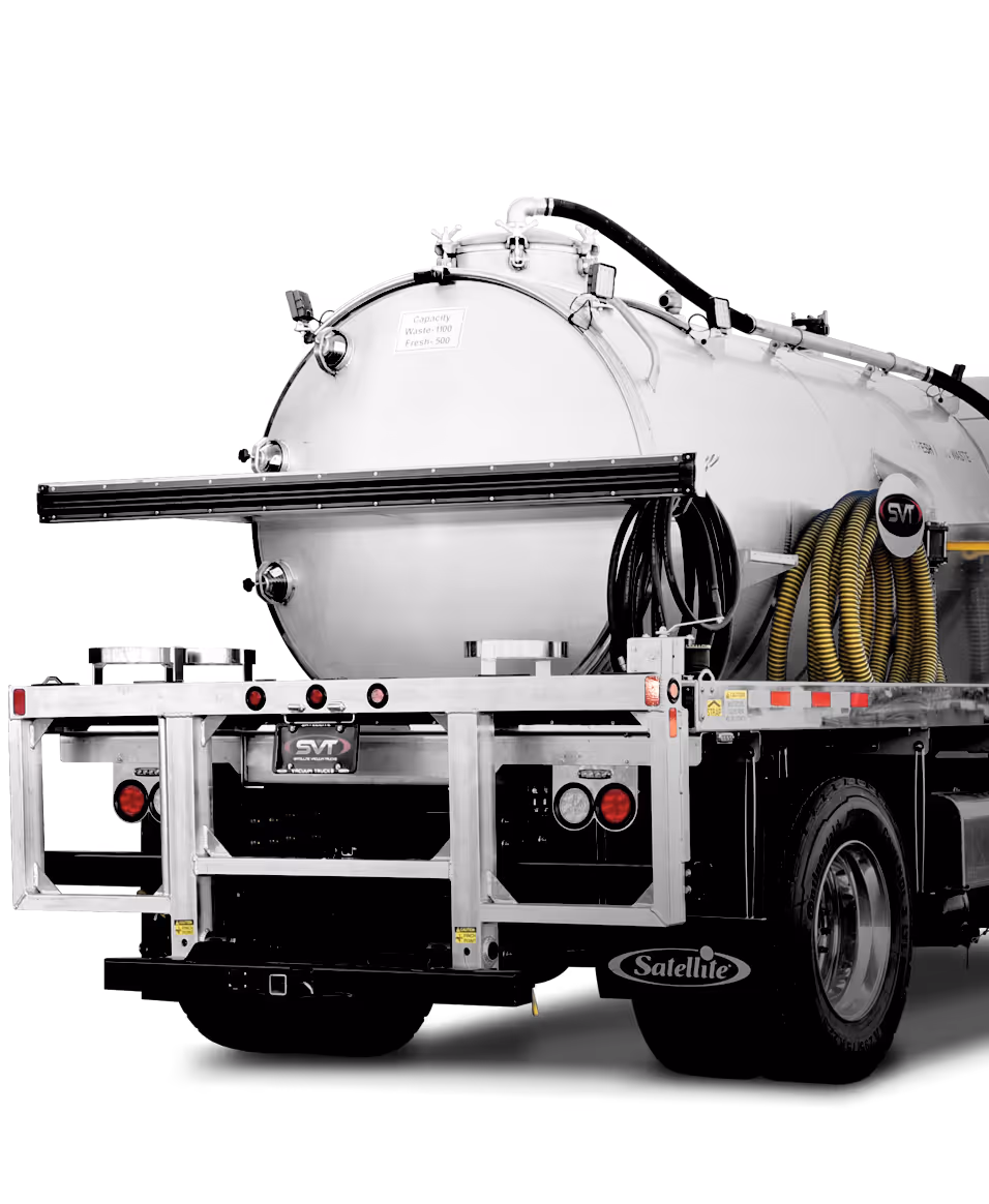 A shiny silver tank on a truck trailer, with hoses coiled on the side and a black background.