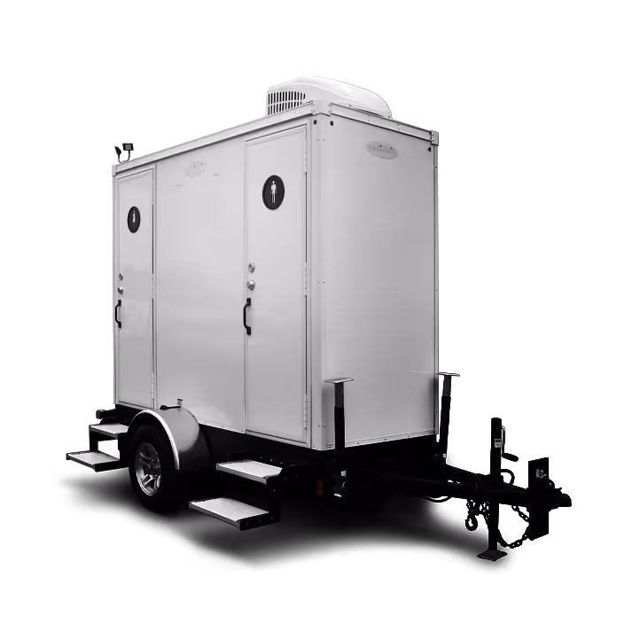 White portable double-door restroom trailer with steps and air conditioning unit on top.