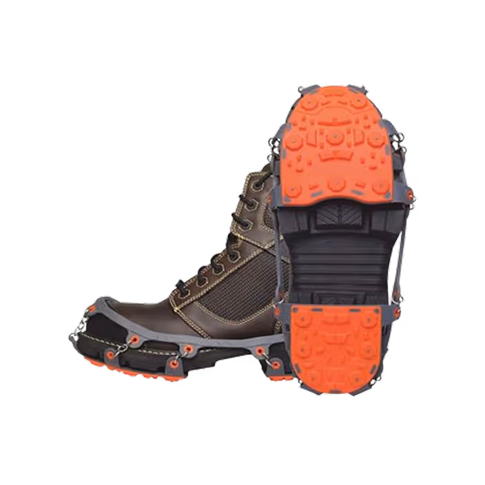 Brown hiking boot with black and orange traction cleats attached to the sole.