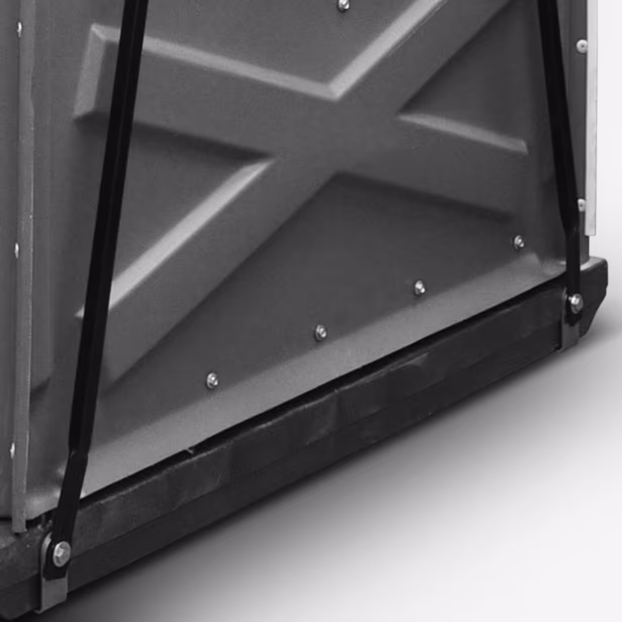 Close-up of a metal panel with an X pattern, secured by bolts and black support bars.
