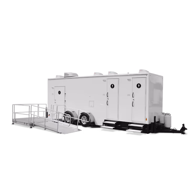 White mobile restroom trailer with two doors, three shower stations, and a ramp for accessibility.