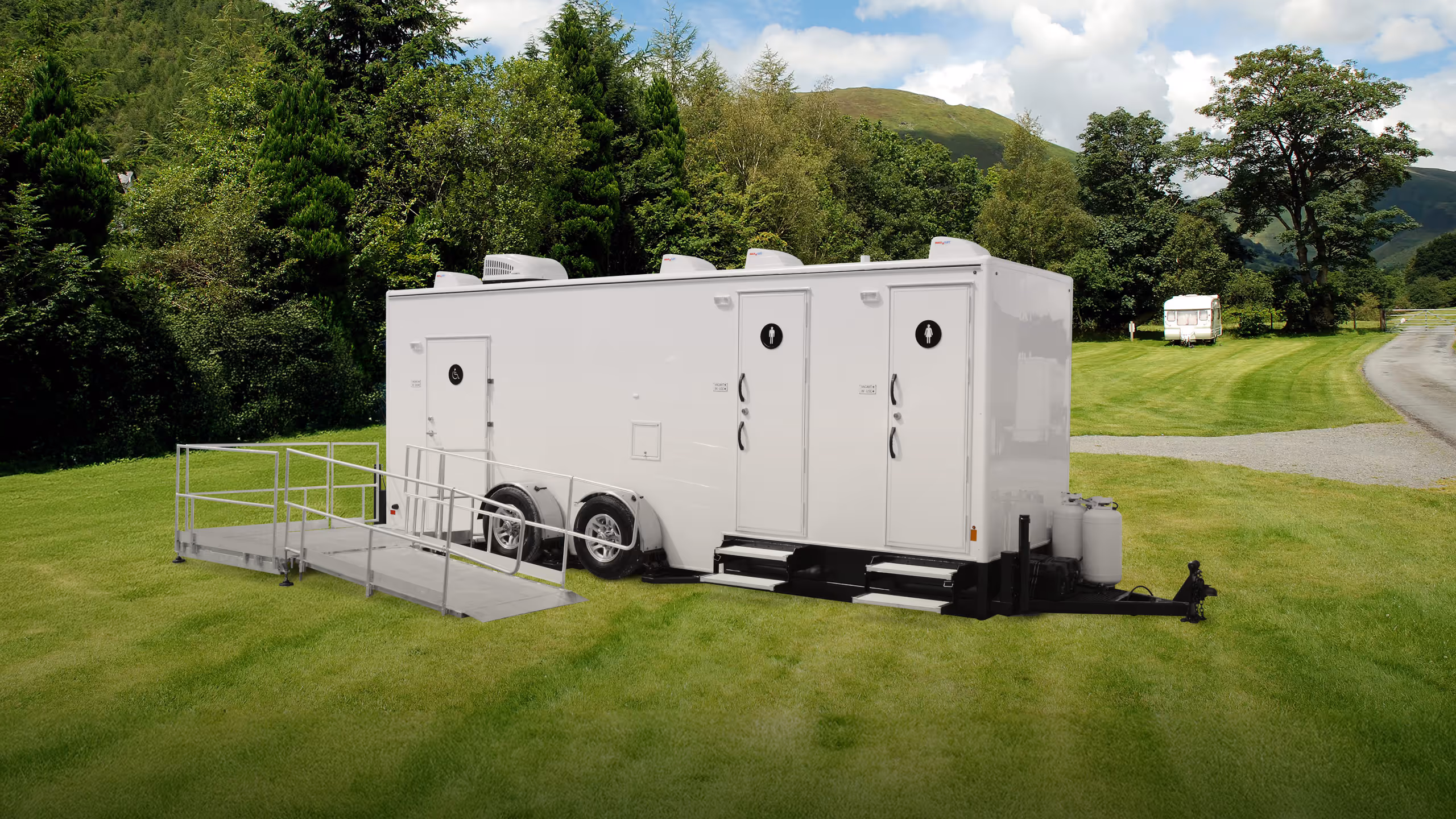 Mobile shower trailer with ADA accessibility, featuring three shower stations and a ramp.