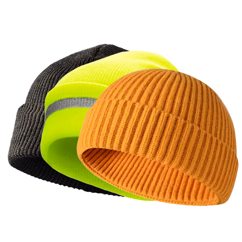 Three knit beanies stacked: black, bright yellow, and orange, showcasing varying textures and