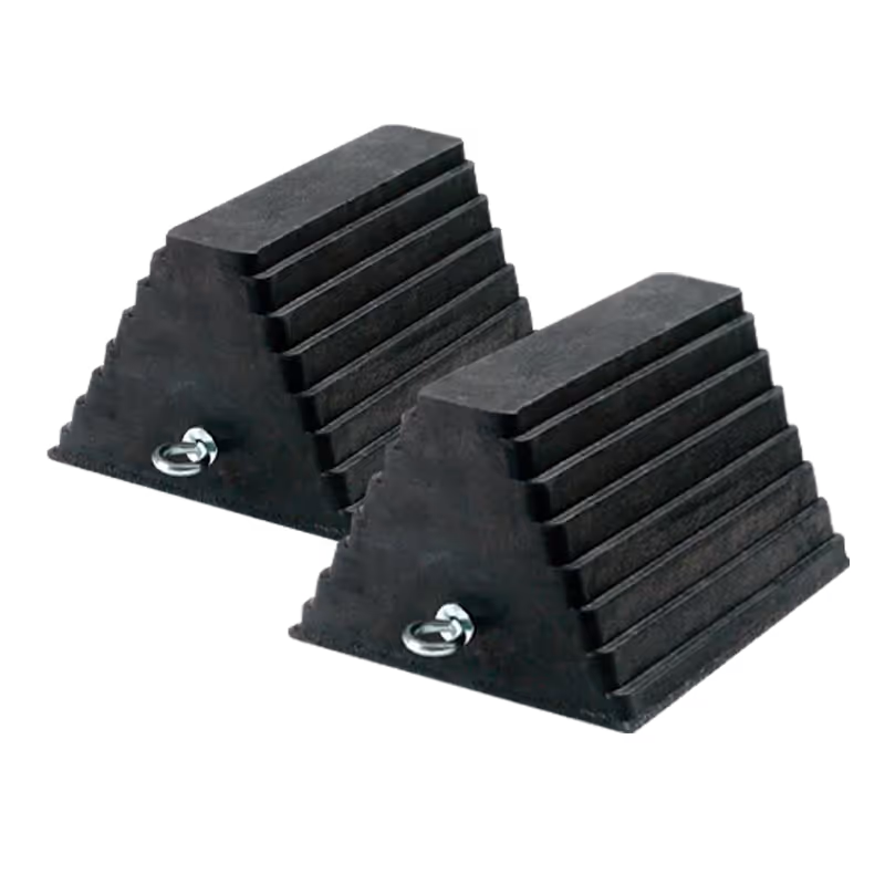 Two black rubber wheel chocks with a ridged surface, featuring metal eye bolts for securing.