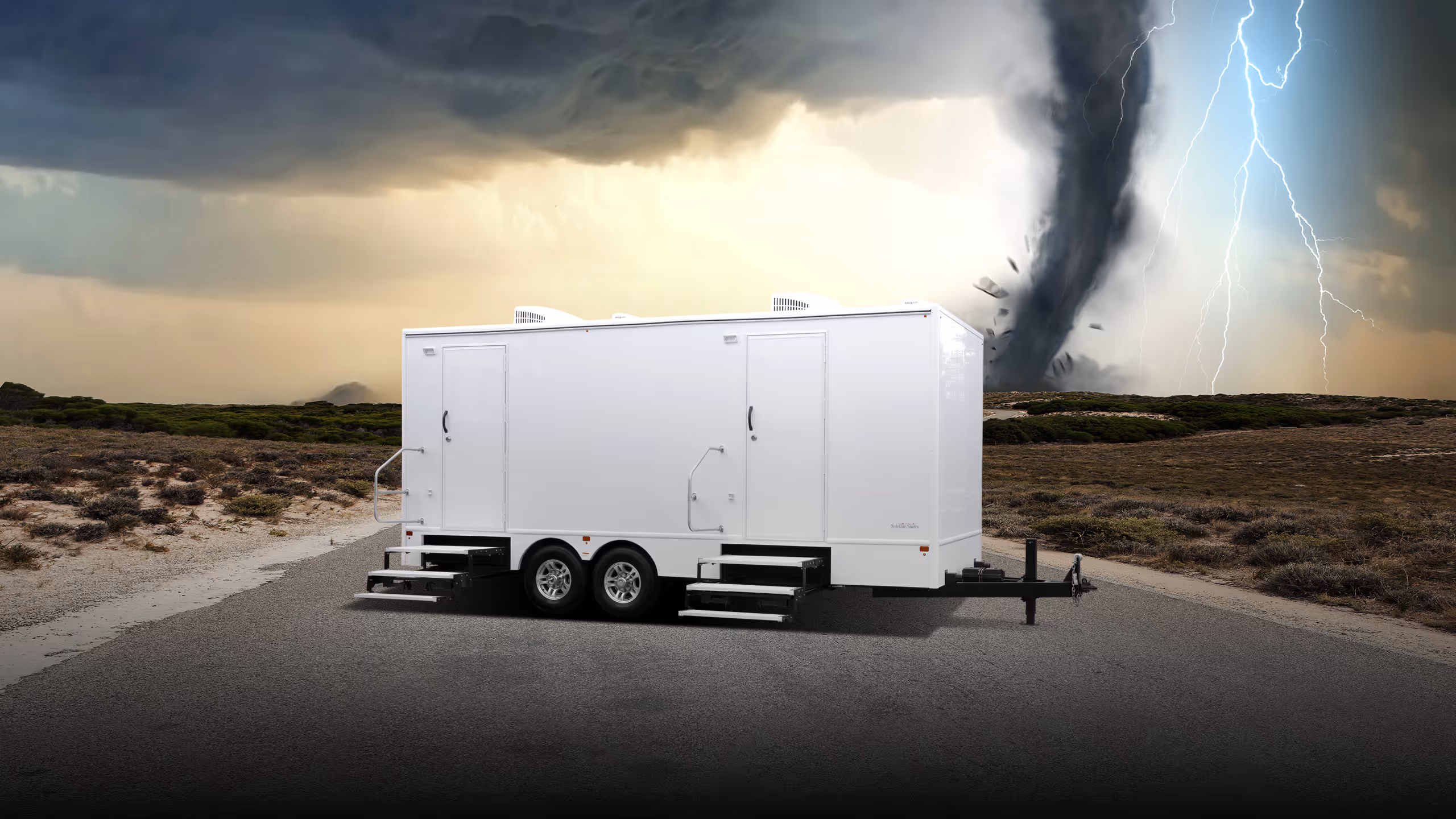 A white six-station restroom trailer in a stormy landscape with a tornado in the background.