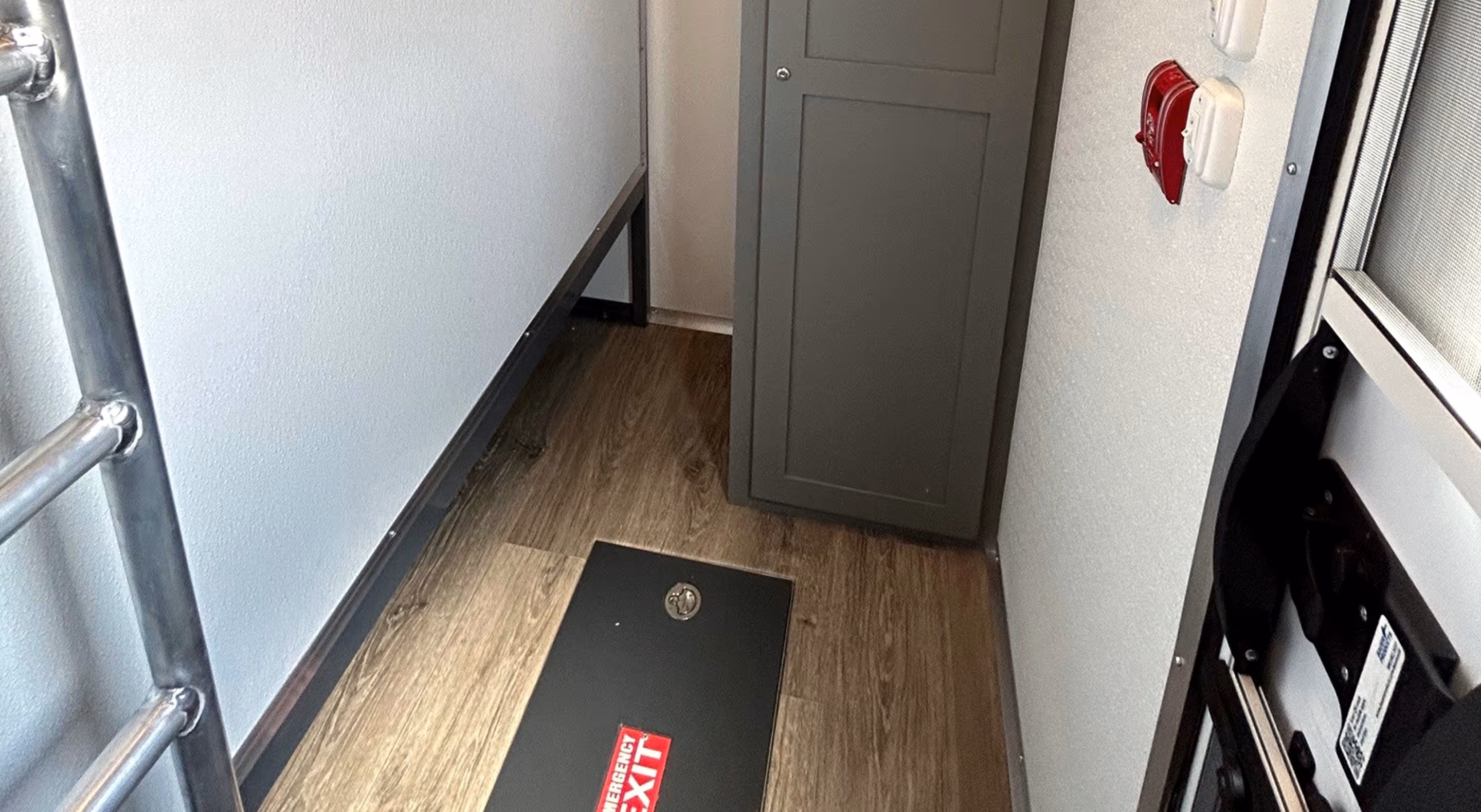 Interior view of a compact 12-man privacy bunk showing a cabinet and floor space.