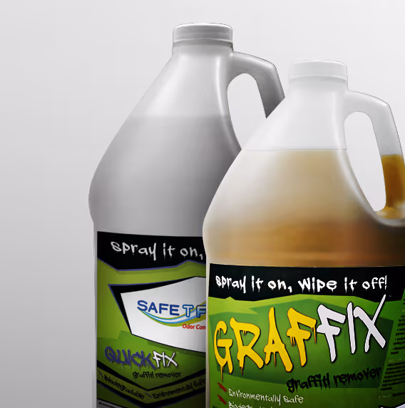 Two bottles of graffiti remover. One labeled "QUICK FIX" and the other "GRAFFIX," both in spray