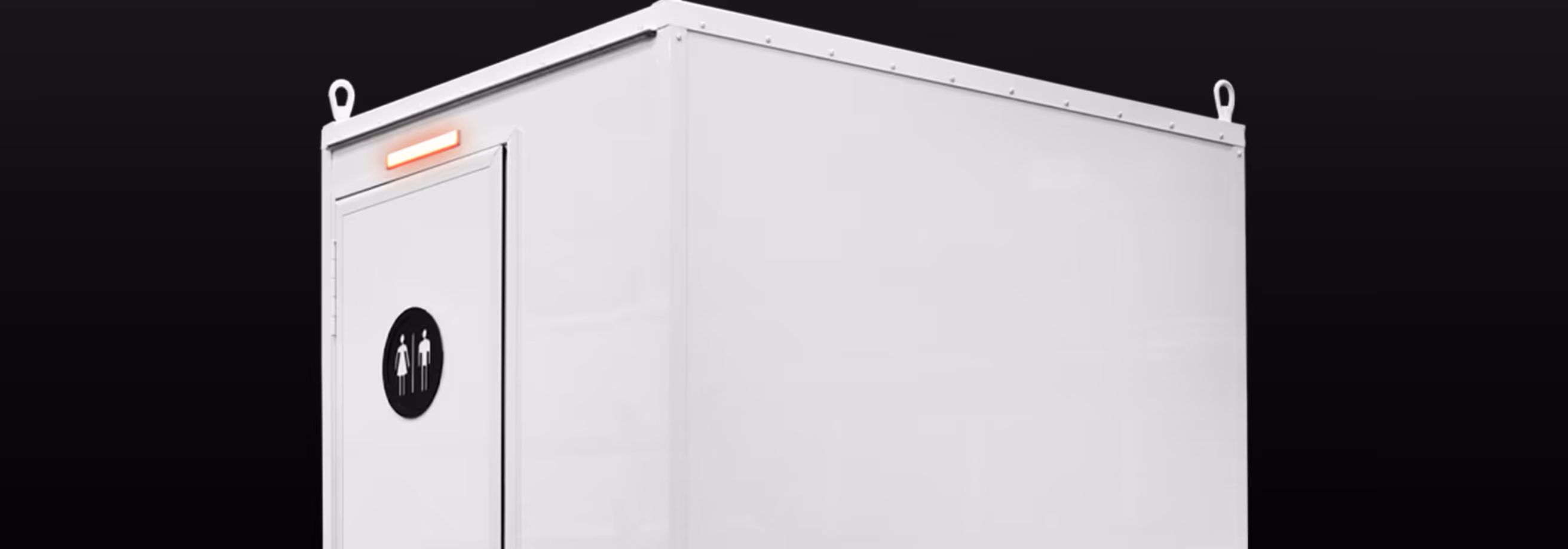 White modular restroom unit with male and female icons on the door and a red light above.