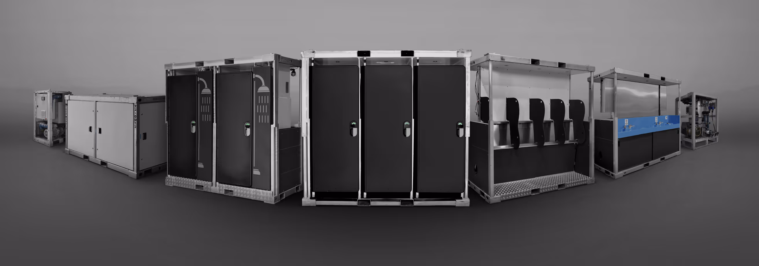 Row of industrial vacuum technology units in black and white with a blue section on one unit.