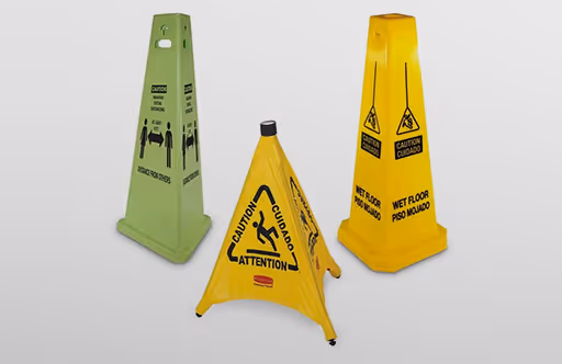 Three caution cones: green for "no smoking," yellow for "wet floor," and orange with bilingual