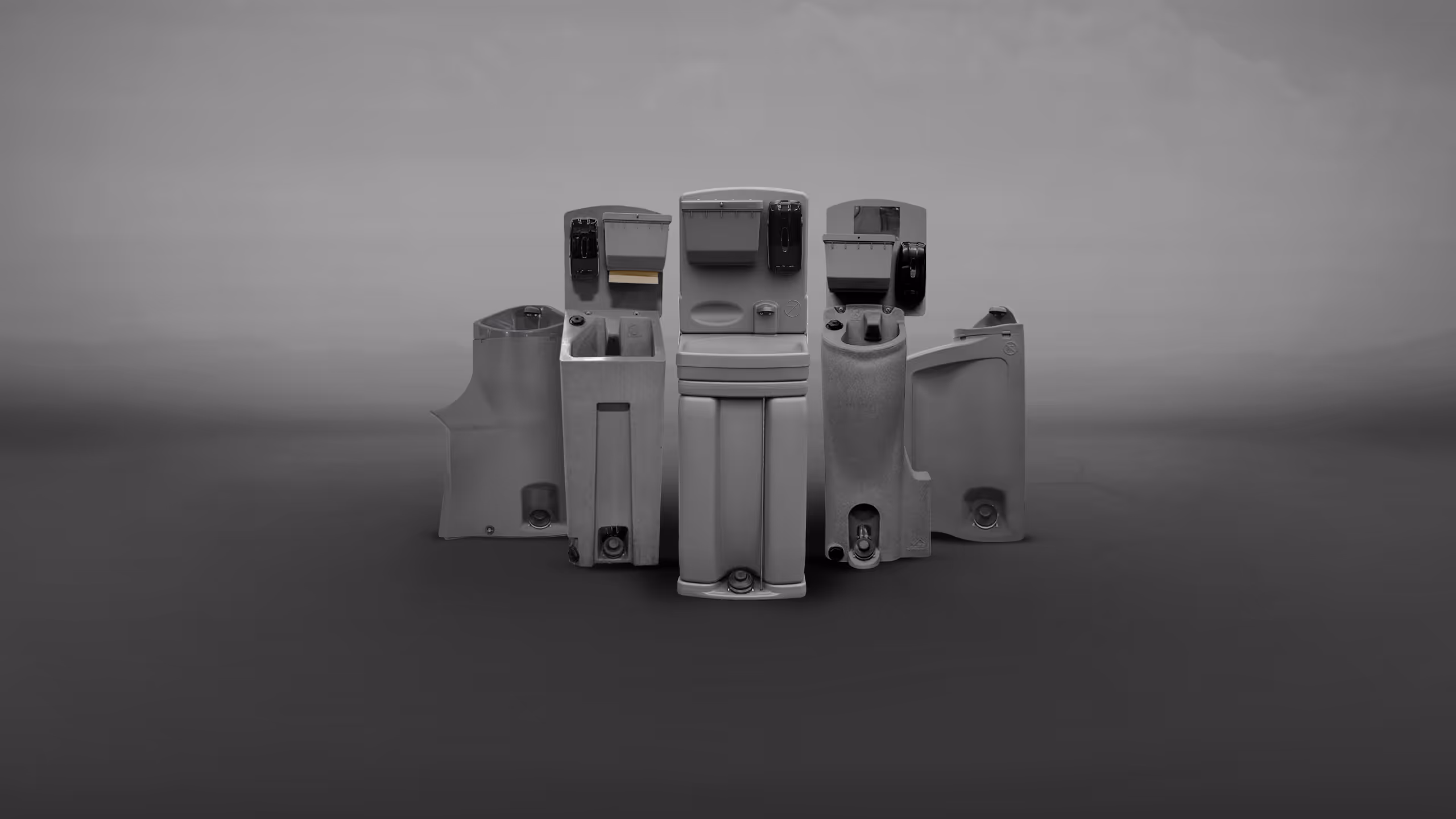 A collection of gray plastic parts arranged in a circular formation against a gray background.