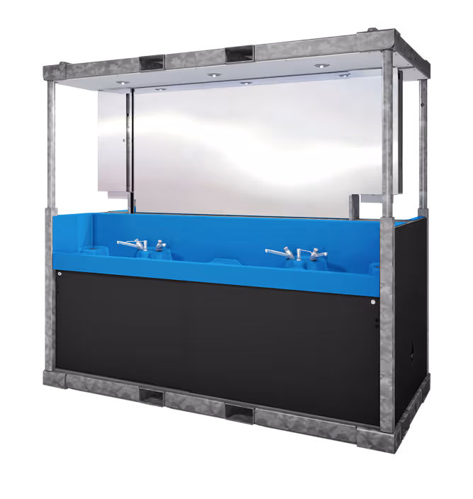 Large industrial handwashing station with blue basins, multiple faucets, and metal frame with overhead lights.