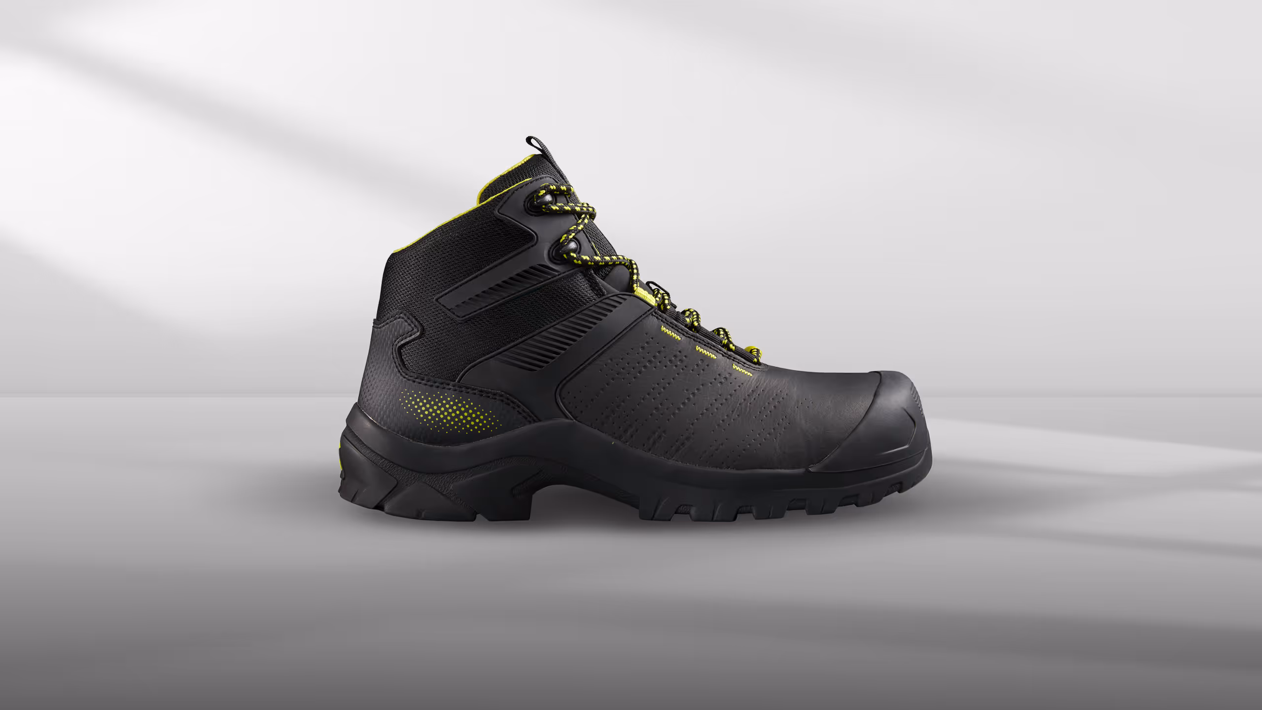 Black and yellow high-top safety boots with reinforced toe and textured design.