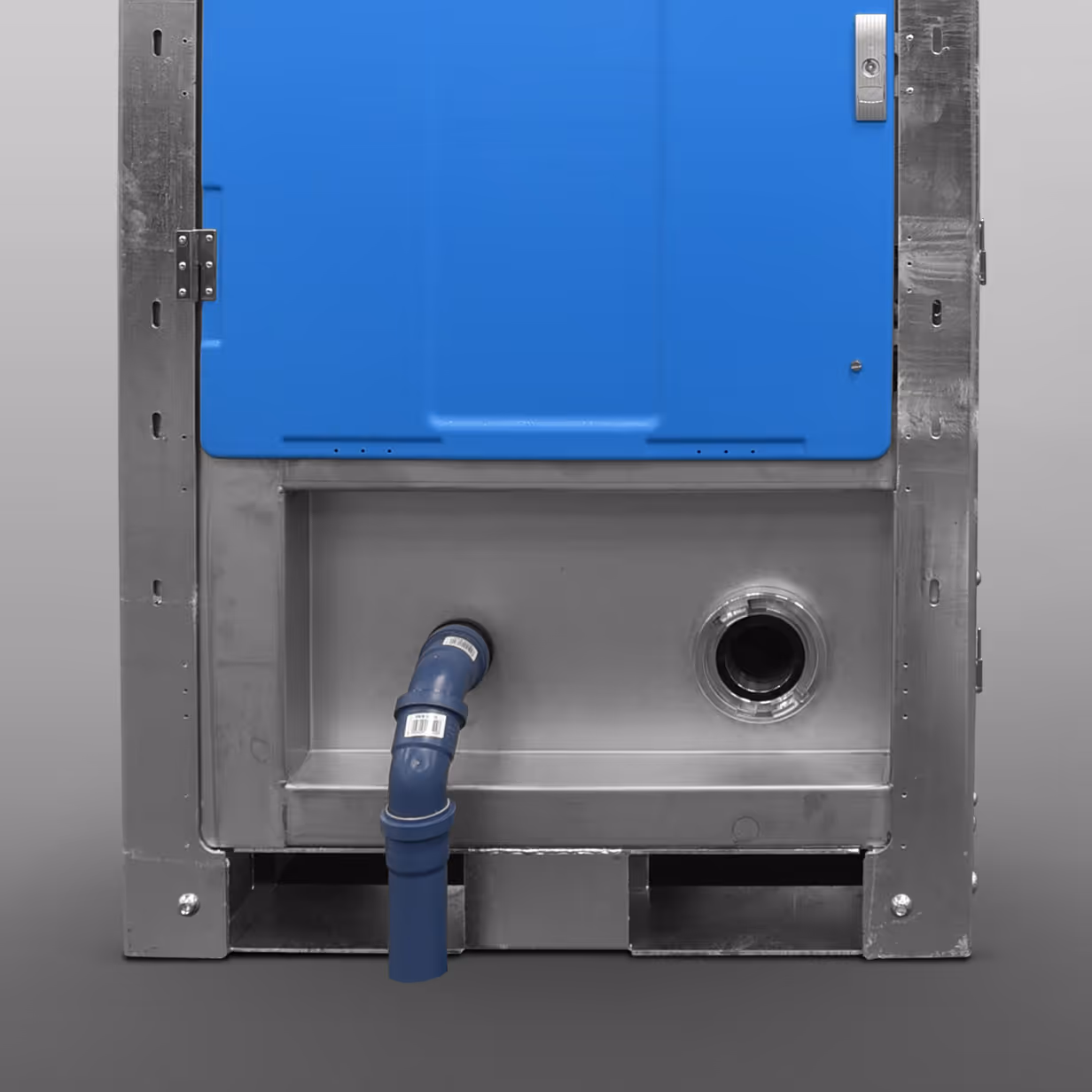 Close-up of a blue modular container's metal base with a blue pipe and circular opening.