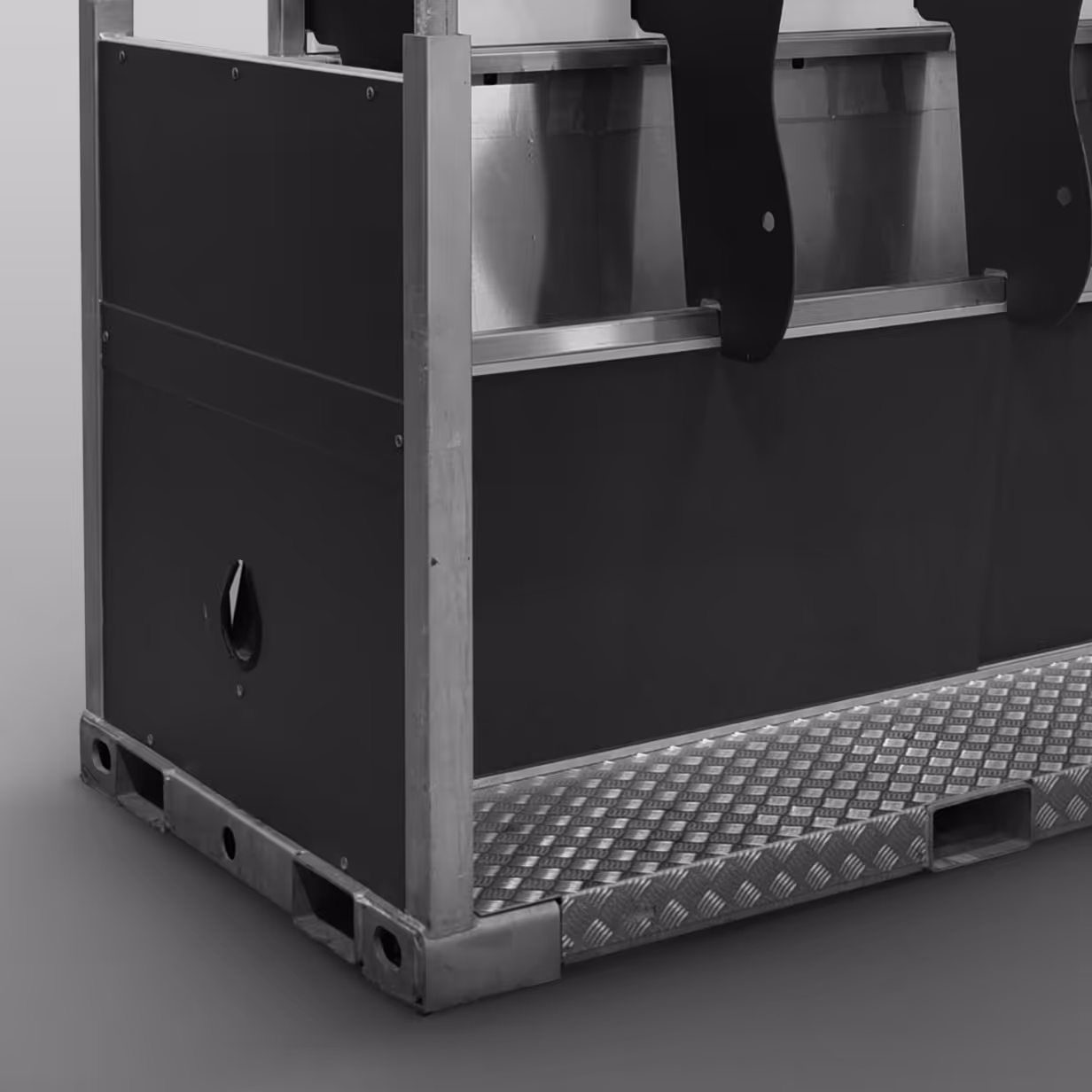 Close-up of a sturdy metal and panel crate with reinforced corners and a textured metal base.