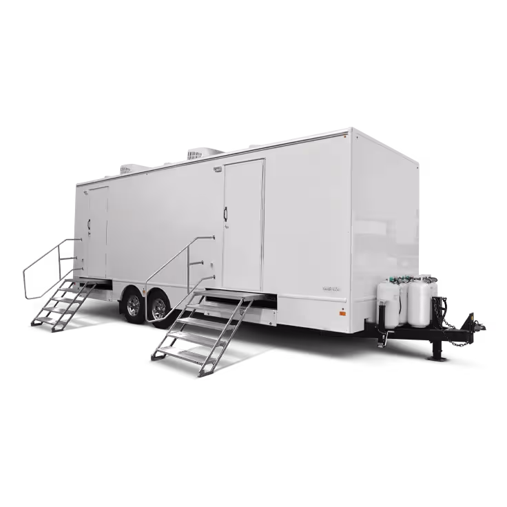 Large white mobile trailer with two entry doors, two staircases, and gas tanks on front hitch.