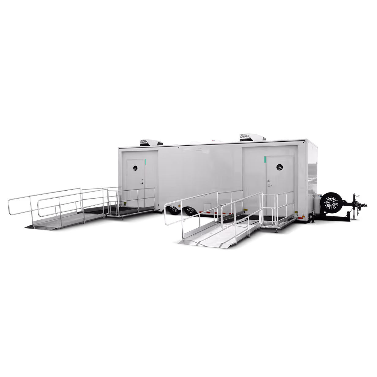 White accessible mobile trailer with two wheelchair ramps and two doors marked with accessibility symbols.