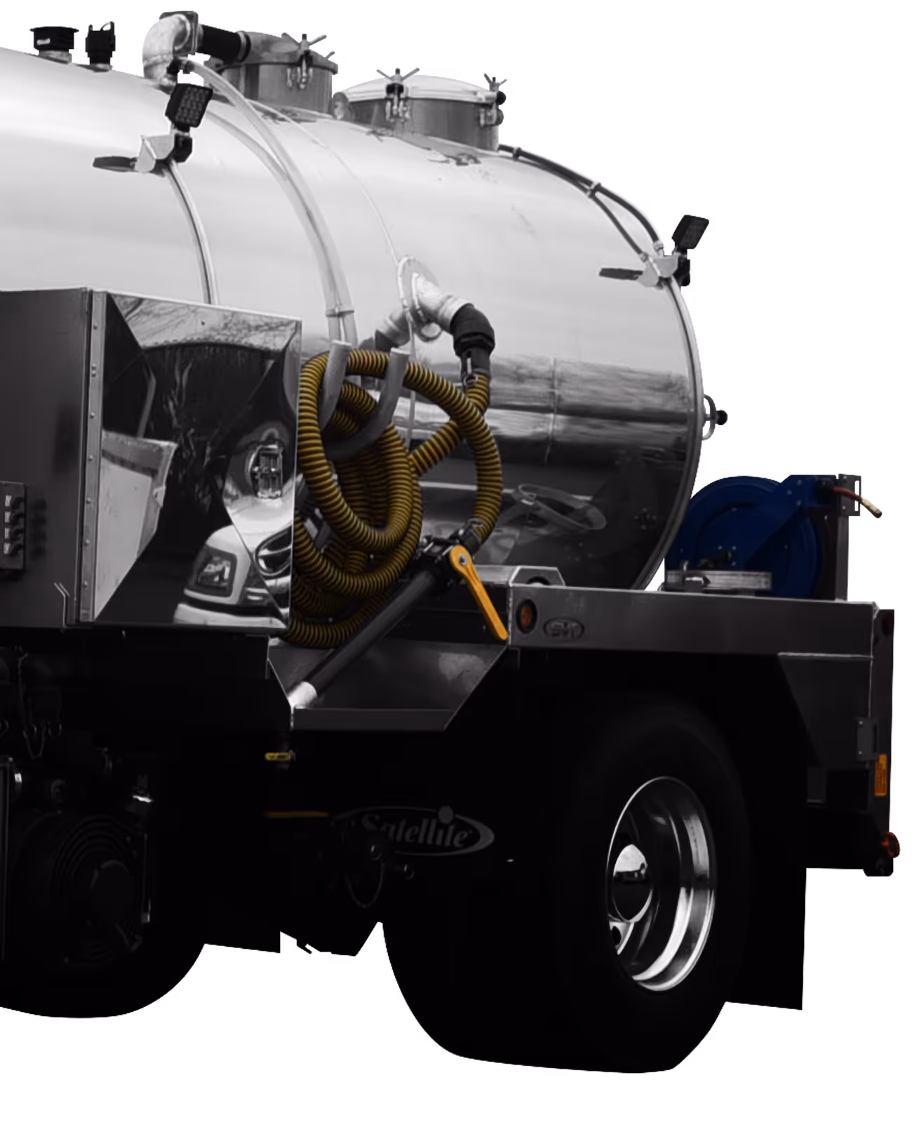 Back section of a tanker truck with coiled yellow hose and shiny metal tank on flatbed.