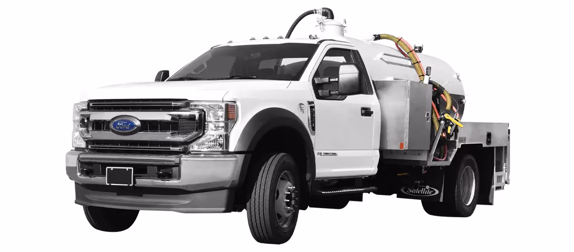 White Ford truck with vacuum or sewer cleaning equipment mounted on its back.