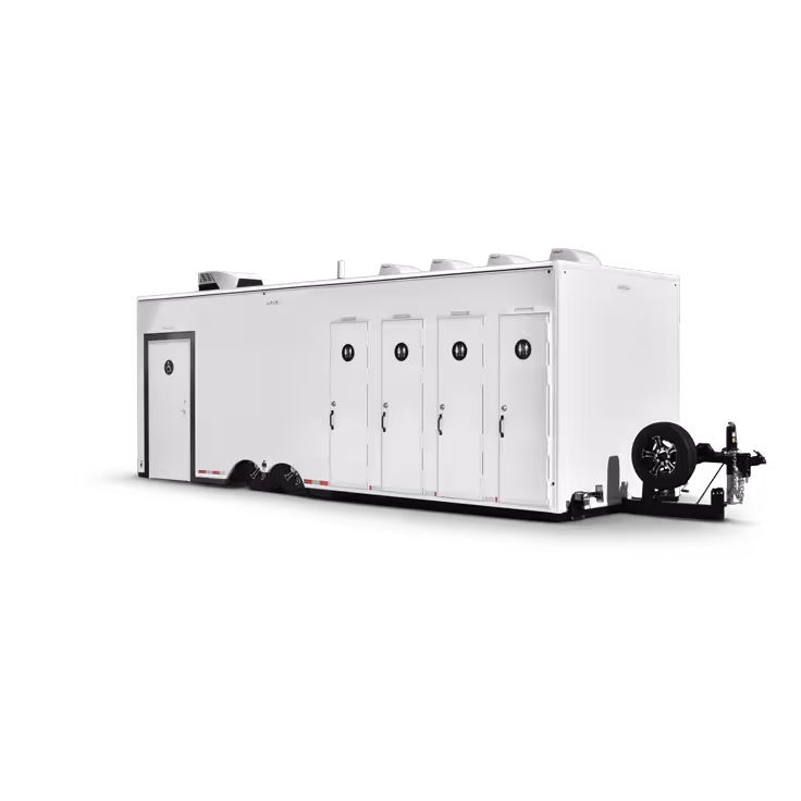 White portable trailer with five restroom doors and a spare tire mounted in front.