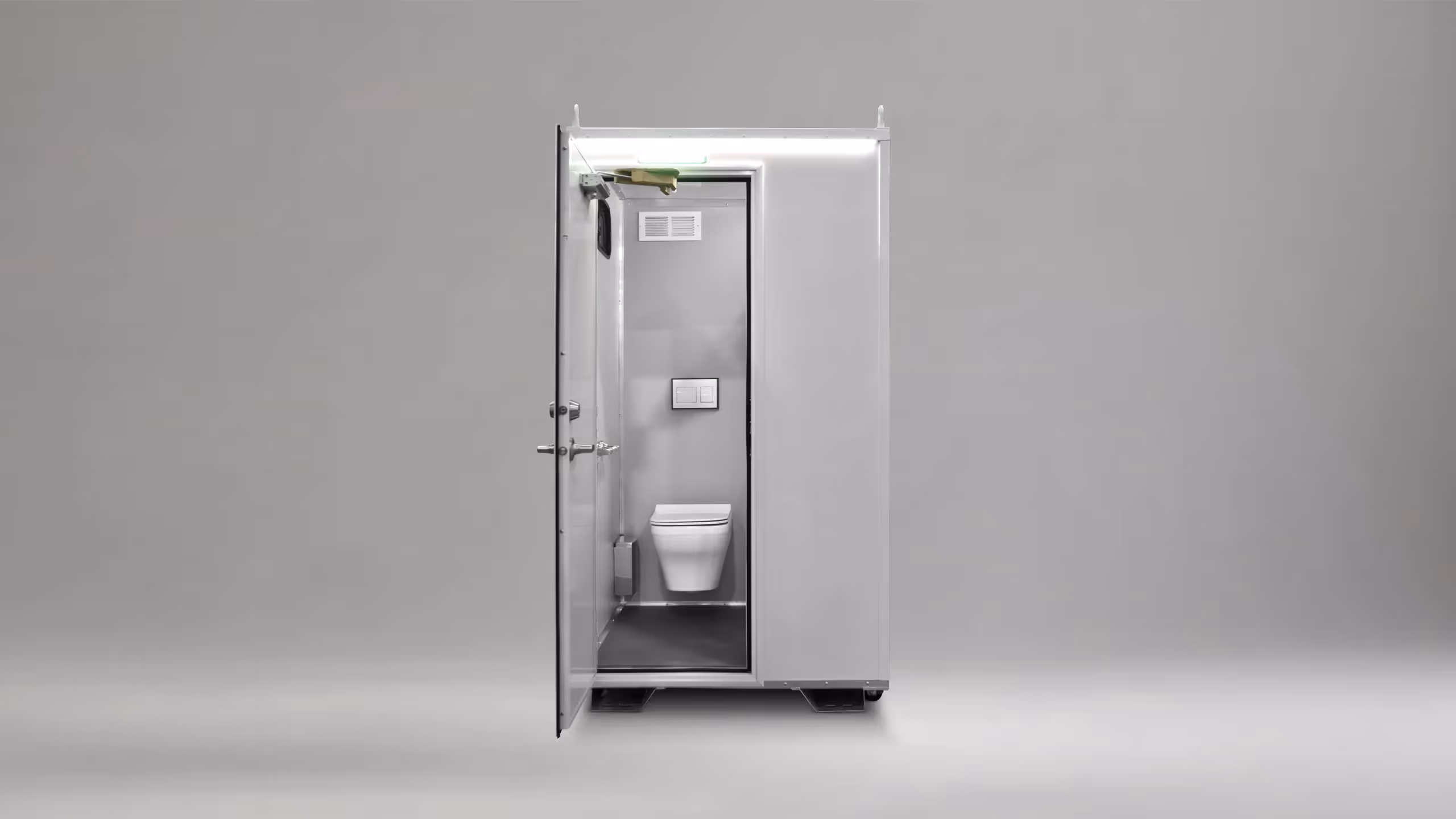 Modern white portable restroom unit with an open door showing a wall-mounted toilet and flush buttons.