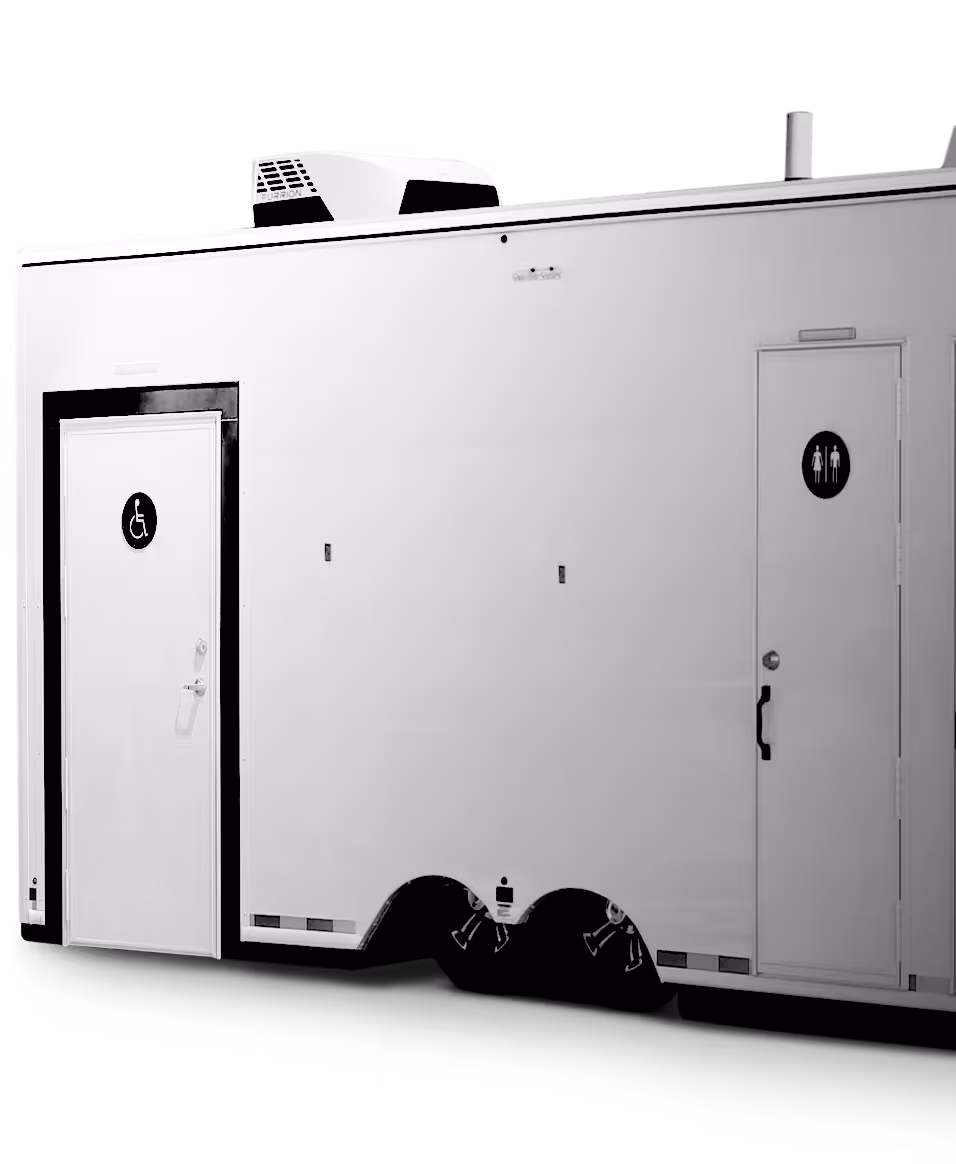 White portable restroom trailer with two doors, one for accessibility and one unisex restroom.