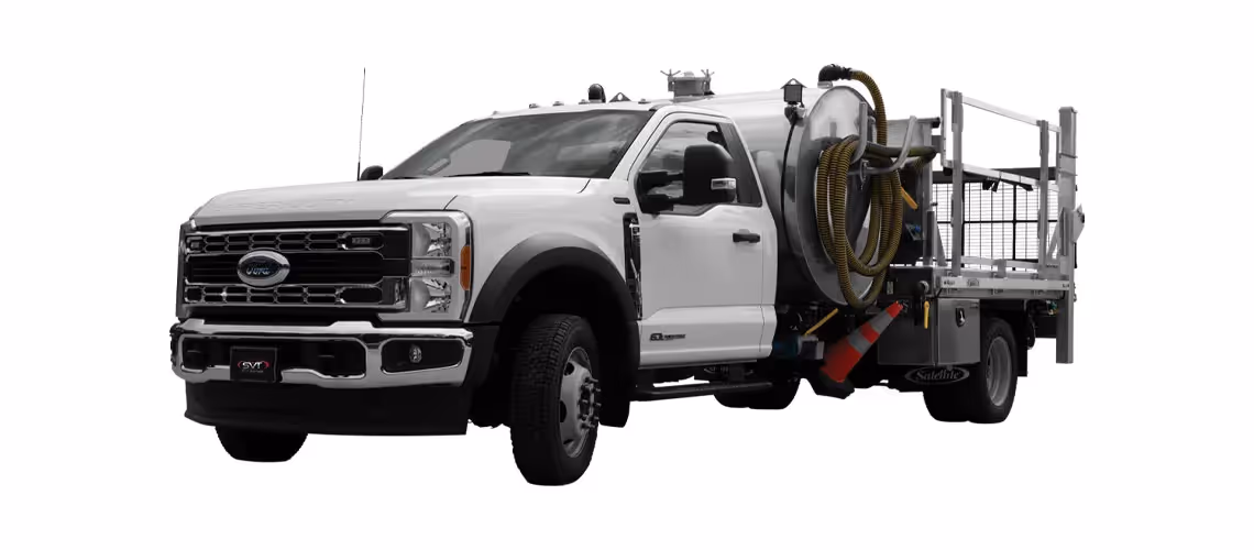 White Ford service truck with a large cylindrical tank and attached hoses on its flatbed.