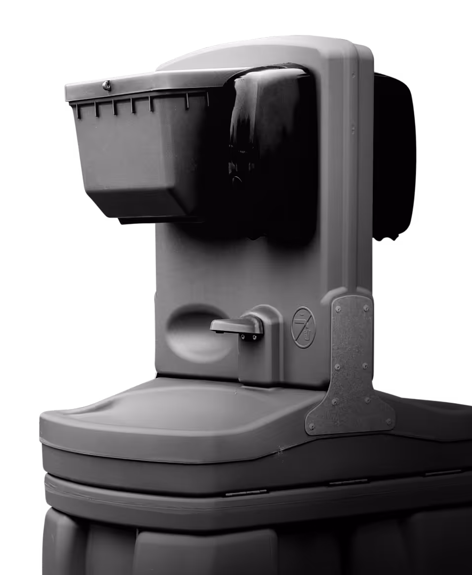 Close-up of a plastic outdoor hand sanitizer dispenser station with a pump and waste bin.