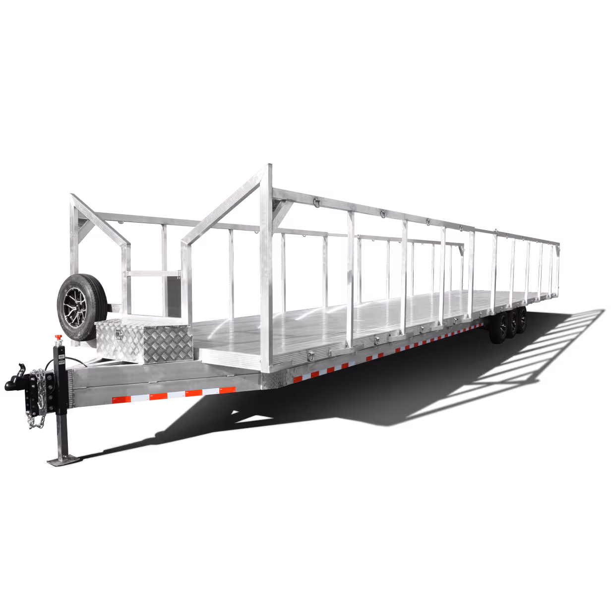 Long metallic flatbed trailer with multiple vertical frame supports and triple axles.