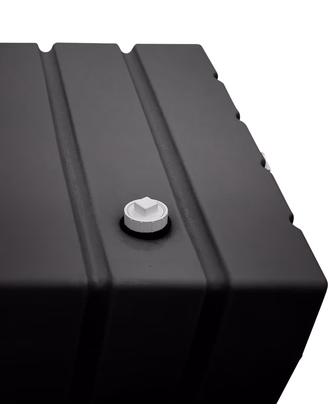 Close-up of a black plastic container with a white screw cap on its grooved top surface.